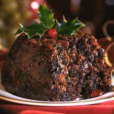 Traditional Christmas pudding topped with holly, served at the Christmas Pudding Club at Three Ways House Hotel